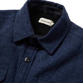 material shot of jacket from the front showing label