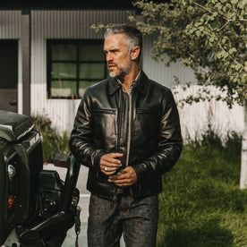 fit model wearing The Moto Jacket in Black Steerhide, looking left