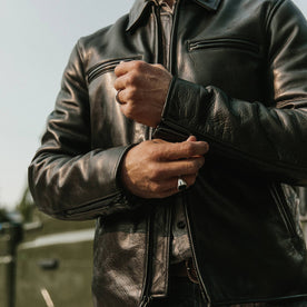 fit model wearing The Moto Jacket in Black Steerhide, zipping up sleeve