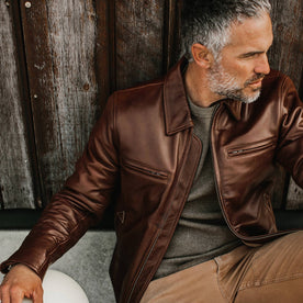 fit model wearing The Moto Jacket in Espresso Steerhide, sitting against building