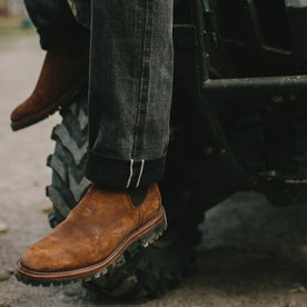 fit model wearing The Ranch Boot in Redwood Waxed Suede, looking left
