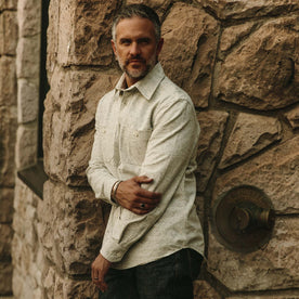 fit model wearing The Utility Shirt in Japanese Kuroki Natural Nep holding his left arm