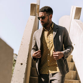 our fit model wearing The Gibson Jacket in Gravel—walking down stairs