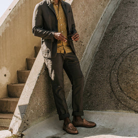 our fit model wearing The Gibson Trouser in Gravel—sunglasses in hands