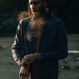fit model wearing The Park Bomber in Navy, playing with sleeve in cold