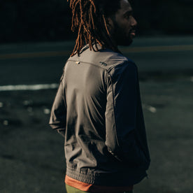 fit model wearing The Park Bomber in Navy, looking right