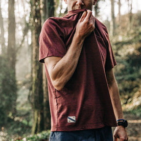 fit model wearing The Merino Tee in Wine, taking a breather