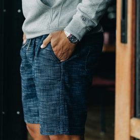 our fit model wearing The Après Short in Indigo Slub—wearing a hoodie early in the morning, cropped shot of pocket