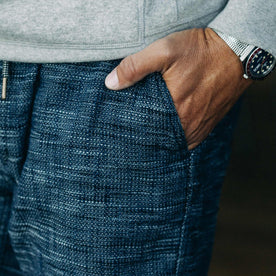 our fit model wearing The Après Short in Indigo Slub—wearing a hoodie early in the morning, cropped shot of pocket detail