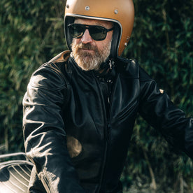 our fit model wearing The Band Collar Moto Jacket—cropped shot looking left