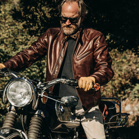 our fit model wearing The Band Collar Moto Jacket—on bike