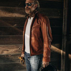 our fit model wearing The Band Collar Moto Jacket—looking left in garage