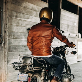 our fit model wearing The Band Collar Moto Jacket—on bike